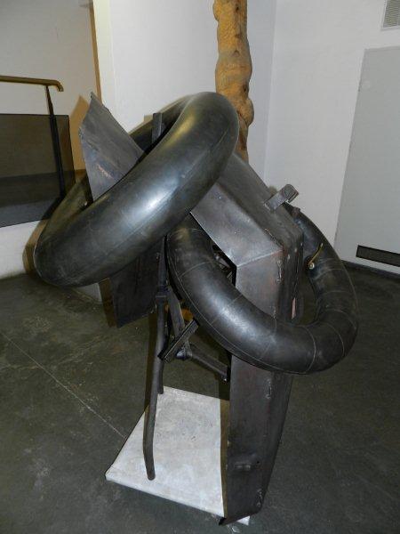 Kategoria zapach: Henryk Morel rzeźba „Kompozycja” 1966 Rzeźba abstrakcyjna. Wykorzystuje związane z przemysłem przedmioty i materiały. Składa się z kilkunastu czarnych, połączonych ze sobą elementów z metalu i gumy.